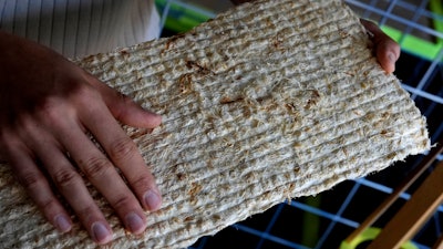 HopfON entrepreneur, Mauricio Fleischer Acuna touches a panel in Munich, Germany, Friday, Sept. 20, 2024. The startup is using the organic waste, some from the hops harvest, to make sustainable building materials like acoustic panels and thermal insulation, with the twofold goal of reducing waste from the construction industry.