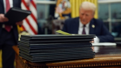 President Donald Trump signs executive orders in the Oval Office of the White House, Monday, Jan. 20, 2025, in Washington.