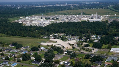 The Fifth Ward Elementary School and residential neighborhoods sit near the Denka Performance Elastomer Plant, back, in Reserve, La., Sept. 23, 2022.