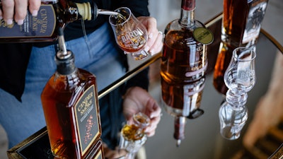 An employee pours a glass of The Bard's product in what will be a new production area at The Bard Distillery, Graham, Ky., March 9, 2025.