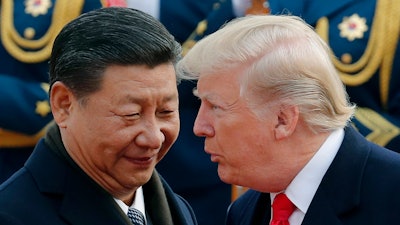U.S. President Donald Trump, right, chats with Chinese President Xi Jinping during a welcome ceremony at the Great Hall of the People in Beijing on Nov. 9, 2017.