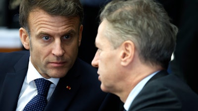 French President Emmanuel Macron, left, speaks with Slovenia's Prime Minister Robert Golob at a round table meeting during an EU summit in Brussels, Monday, Feb. 3, 2025.