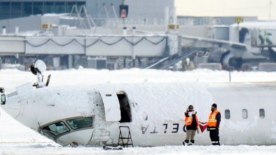 A Delta Air Lines plane lies upside down at Toronto Pearson Airport on Tuesday, Feb. 18, 2025.