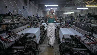 Abdul Sattar, 70, operates a power loom at a workshop in Bhiwandi, India, Feb. 25, 2025.