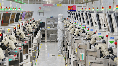 A man works at a manufacturer of Integrated Chip encapsulation in Nantong in eastern China's Jiangsu province on Friday, Sept. 16, 2022.