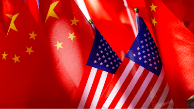 American flags are displayed with Chinese flags on top of a trishaw on Sept. 16, 2018, in Beijing.